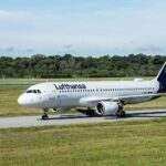 A Lufthansa Airbus A320 jet taxiing on a sunny day at Hamburg Airport, Germany.
