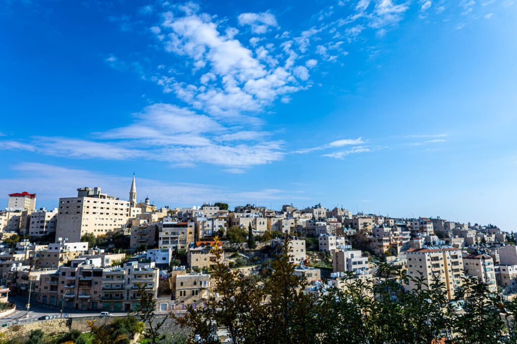 Beautiful panoramic view of Bethlehem cityscape under a vibrant blue sky, showcasing historical architecture.