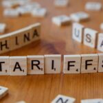 Wooden letter blocks spelling tariffs, China, and USA representing trade relations.