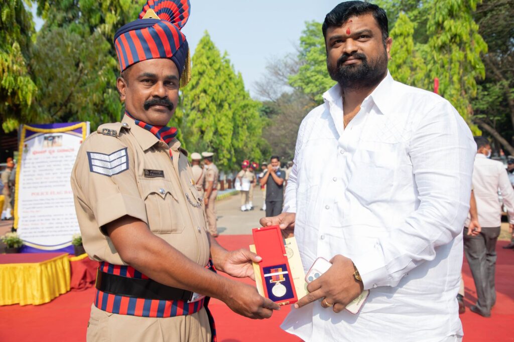 Police officer awarded honorary medal at outdoor ceremony