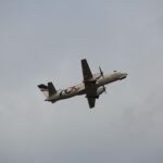 Rex Airlines Saab 340B captured soaring through cloudy skies above Melbourne Airport, Victoria.