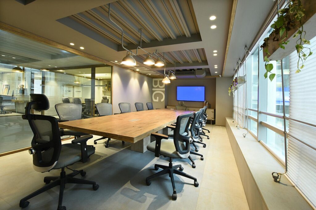Sleek and modern empty conference room with stylish swivel chairs and a wooden table.