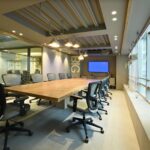 Sleek and modern empty conference room with stylish swivel chairs and a wooden table.