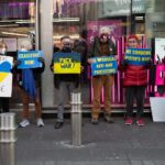 Protesters in New York holding signs advocating for peace and anti-war movements.
