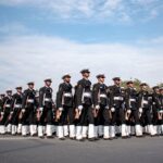 Indian naval officers in uniform marching in formation, showcasing discipline and unity during a parade in New Delhi.