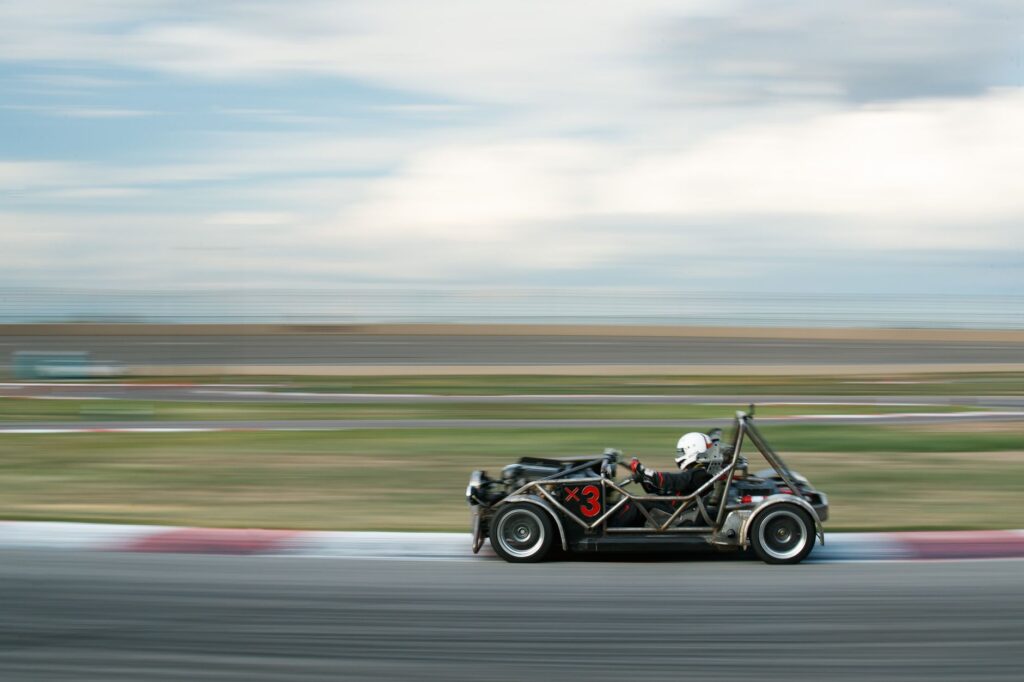 Dynamic shot of a race car speeding on a track, creating motion blur.