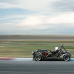 Dynamic shot of a race car speeding on a track, creating motion blur.