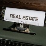 Close-up of a retro typewriter with 'Real Estate' text on paper.