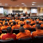 Firefighters in orange uniforms attend a strategic training session in Mato Grosso, Brazil.