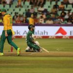 Dynamic cricket scene with players in action on the field during a match.