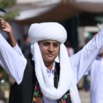 Teenage boy in traditional Baloch attire celebrates a cultural festival in Pakistan.