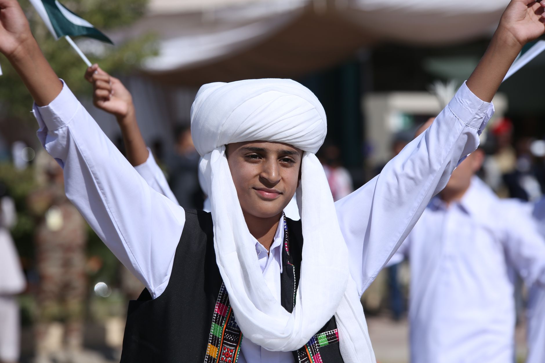 Teenage boy in traditional Baloch attire celebrates a cultural festival in Pakistan.