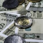 Detailed view of Indian rupee banknotes and coins, showcasing currency and finance concepts.