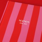 Red and pink striped agenda book for 2026-2027, perfect for planning.