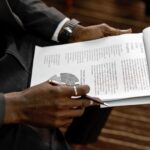 Business professional reviewing financial documents with charts and graphs during a meeting.