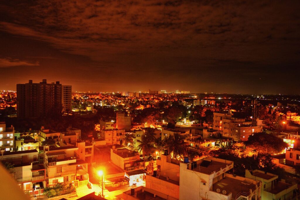 Vibrant view of Bengaluru cityscape at night, showcasing illuminated buildings and dynamic skyline.