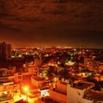 Vibrant view of Bengaluru cityscape at night, showcasing illuminated buildings and dynamic skyline.