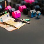 Miniature houses, euro bills, and a house key symbolize real estate investment and property transactions.