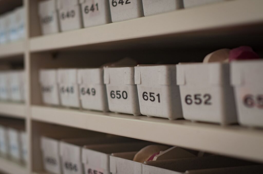 Close-up of numbered storage containers on shelves in an organized setting.