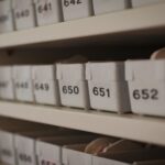 Close-up of numbered storage containers on shelves in an organized setting.