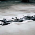 An aerial view of a structure overwhelmed by a river flood in Bern, Switzerland.
