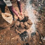 A person prepares pachamanca, an ancient Peruvian cooking method, in Cusco.