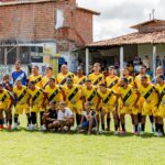 Local amateur football team poses for a group photo before starting their match.