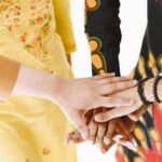Close-up of diverse hands stacked, symbolizing teamwork and unity.