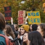 Protesters in Vancouver holding signs advocating for food security and human rights.