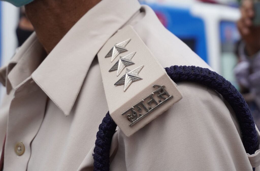 Detailed view of a police officer's shoulder insignia in India.