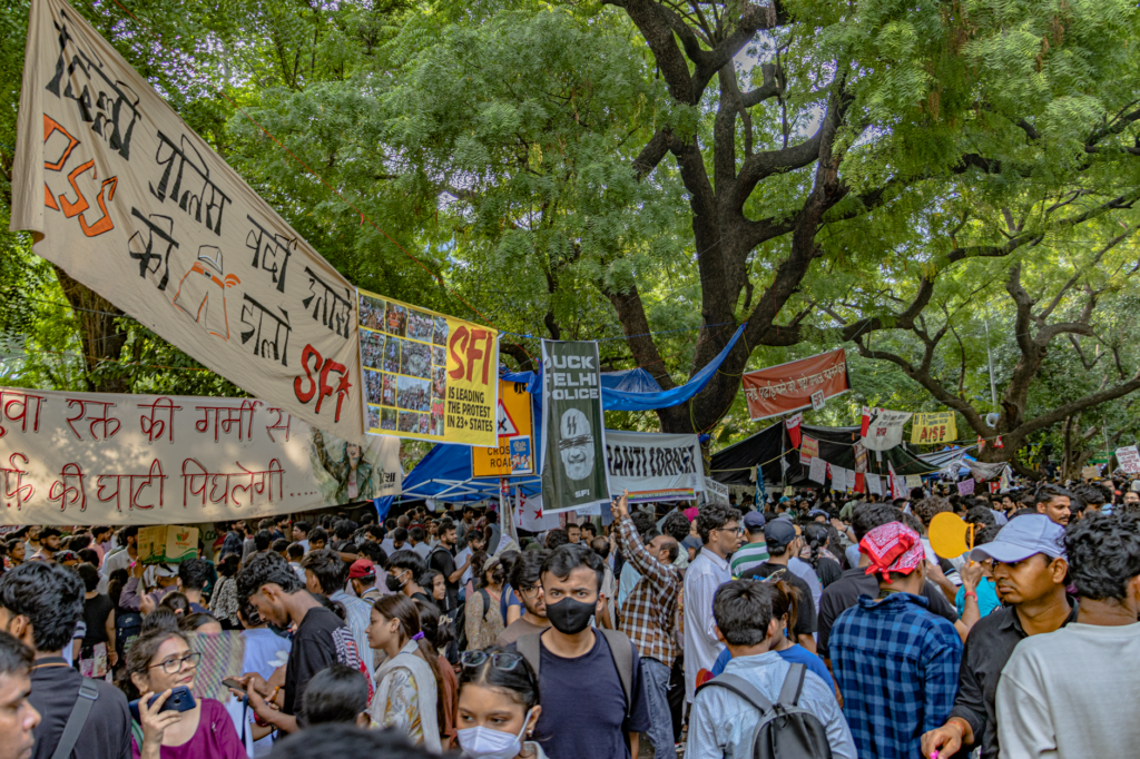 Students gather in New Delhi for a peaceful protest, displaying banners and signs at Jantar Mantar.