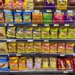 Colorful snack packages neatly displayed in a supermarket aisle showcasing Asian food variety.