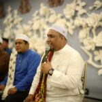 Muslim men in traditional attire engage in a religious gathering in Kuala Lumpur, Malaysia.