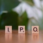 Wooden letter blocks spelling IPO on a table, symbolizing investment opportunities.