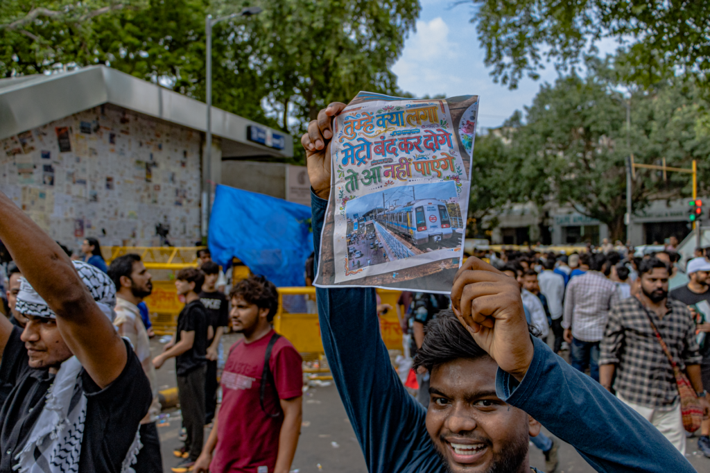 Protesters congregate at Jantar Mantar, New Delhi, holding up signs for peaceful demonstration.