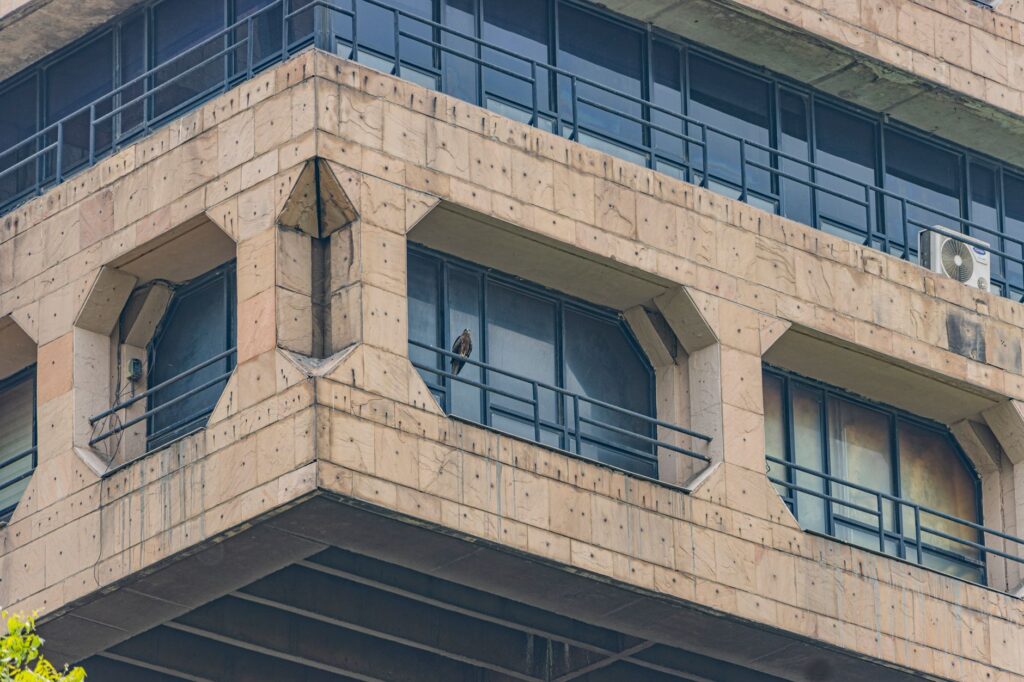 Close-up of a Brutalist building facade in New Delhi, showcasing architectural symmetry.