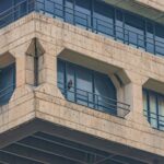 Close-up of a Brutalist building facade in New Delhi, showcasing architectural symmetry.