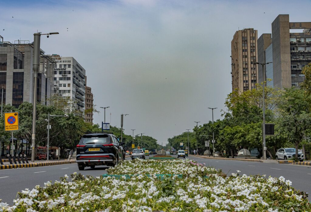 Explore the urban architecture and vibrant street life of New Delhi, India, captured in a dynamic street scene.