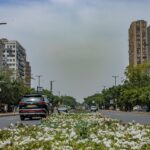 Explore the urban architecture and vibrant street life of New Delhi, India, captured in a dynamic street scene.
