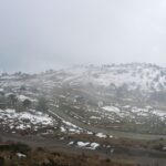 A serene snowy landscape in Tawang captured on a misty winter day.