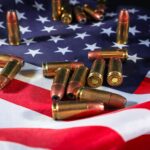 Close-up of ammunition on the American flag, signifying defense and patriotism.
