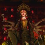 Vibrant ceremonial idol of Goddess Durga showcased at a traditional Durga Puja festival.