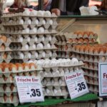 Stacks of fresh eggs in trays on sale at a traditional market in Frankfurt.