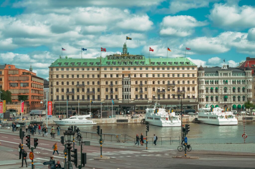 Picturesque waterfront area in Stockholm with iconic architecture and ferries docked.