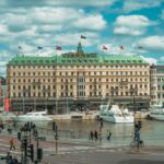 Picturesque waterfront area in Stockholm with iconic architecture and ferries docked.