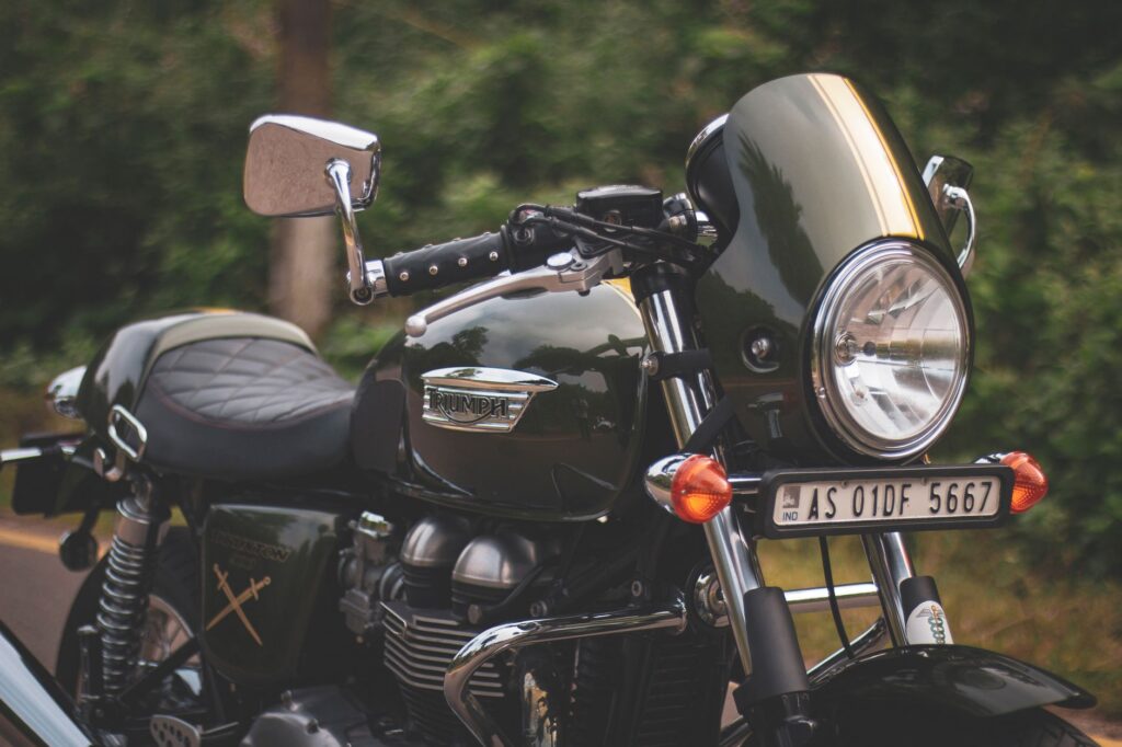 Close-up of a vintage Triumph motorcycle parked outdoors, showcasing its classic design.