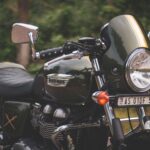 Close-up of a vintage Triumph motorcycle parked outdoors, showcasing its classic design.