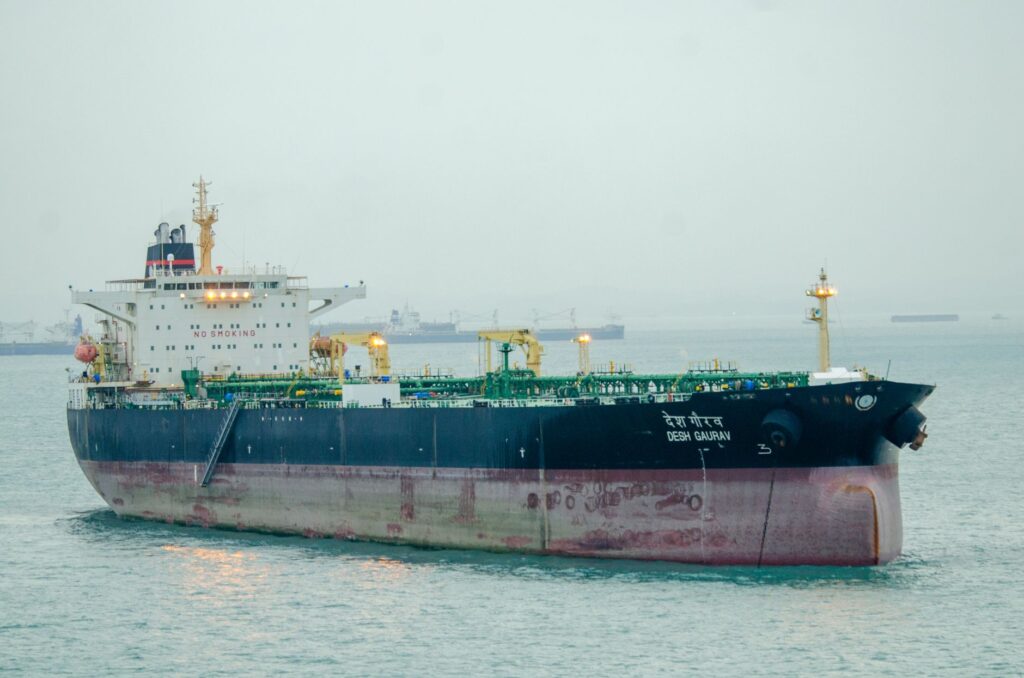 Large cargo ship 'Desh Gaurav' sailing in open sea, showcasing maritime transport.