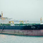 Large cargo ship 'Desh Gaurav' sailing in open sea, showcasing maritime transport.