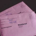 Close-up of German election ballot envelopes for the Bundestag election, showcasing voting documents.